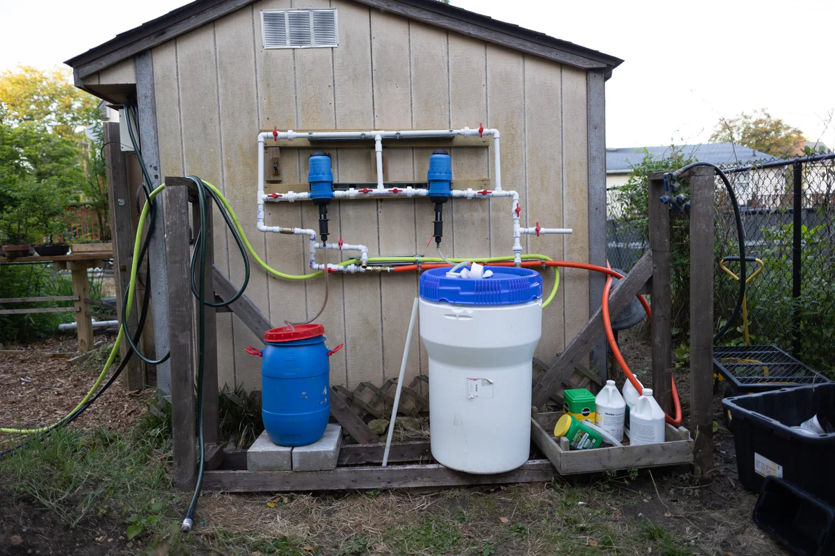 Garden shed with tanks and plumbing, May 2026